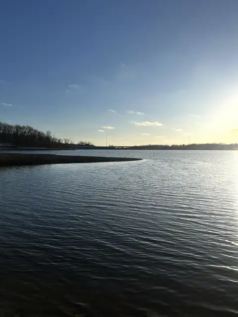 Serene waters reflecting the warm glow.